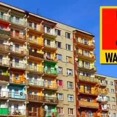 Czy komornik może zająć mieszkanie, którego jestem współwłaścicielem? Ostrzeżenie na tle bloku mieszkalnego.